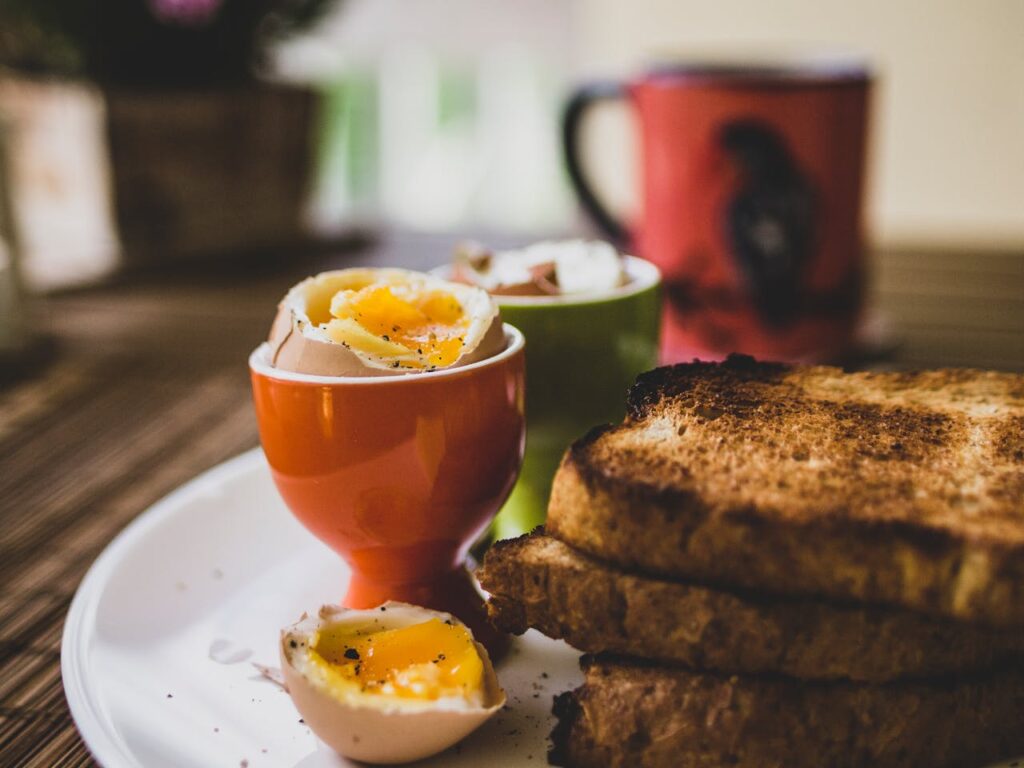 Delicious breakfast featuring soft-boiled eggs and toasted bread, perfect start to the day.